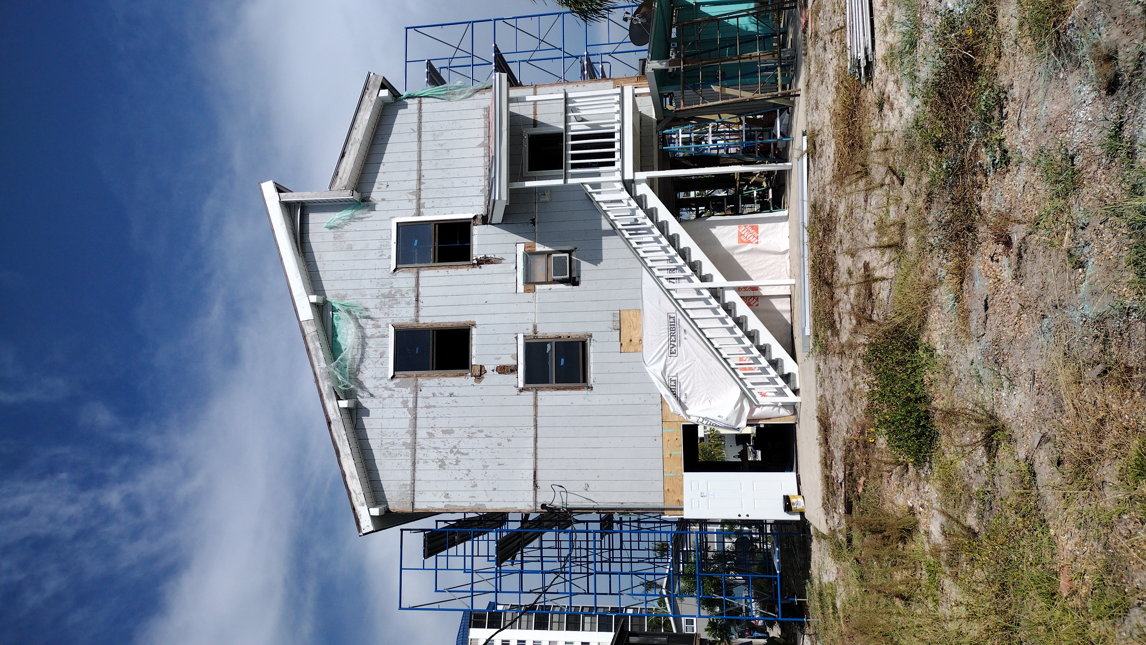 Rotten original wood board siding before removal — Bell Engineering & Construction, Palm Beach County