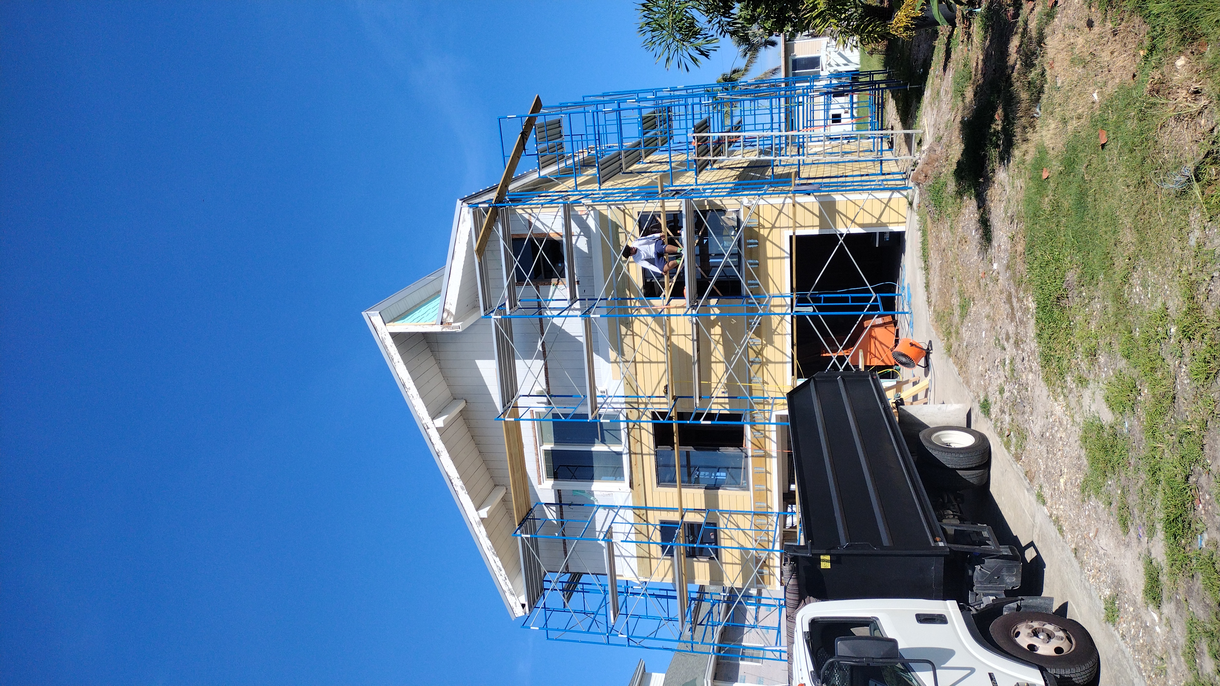 Scaffolding up and new James Hardie fiber-cement siding going on over the old wood — Bell Engineering & Construction
