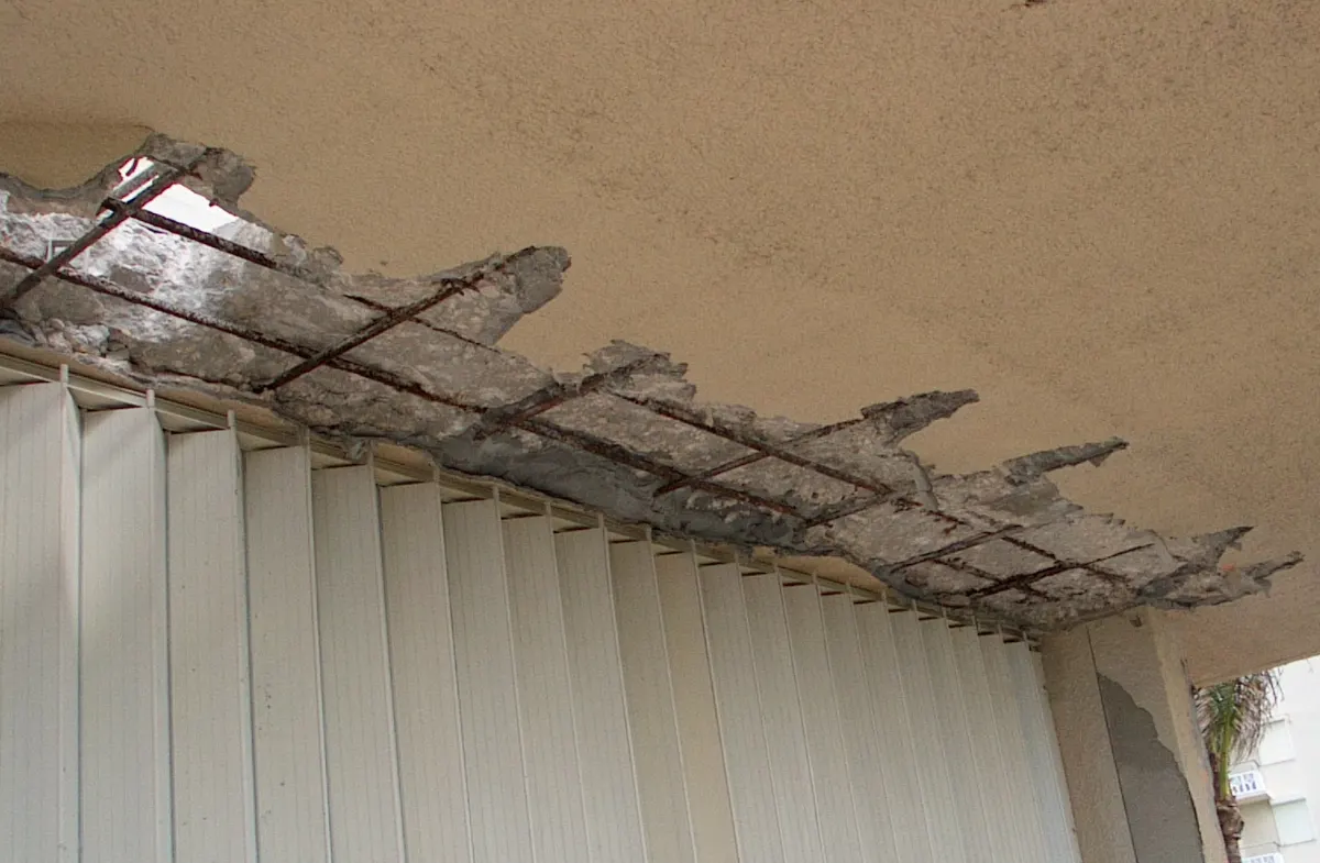 Balcony soffit at North Ocean One chipped open to expose corroded reinforcing steel