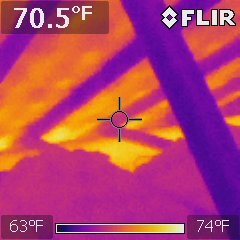 FLIR infrared capture of attic rafters and roof decking reading 70.5 degrees Fahrenheit on a 63 to 74 degree scale