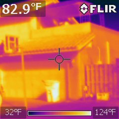 FLIR infrared capture of a house and garage from the street reading 82.9 degrees Fahrenheit on a 32 to 124 degree scale