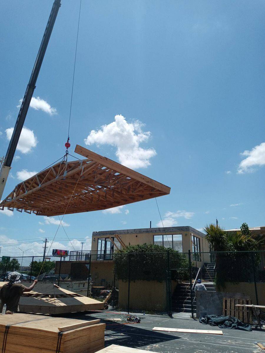 Bell Engineering crane setting a roof truss in Palm Beach County