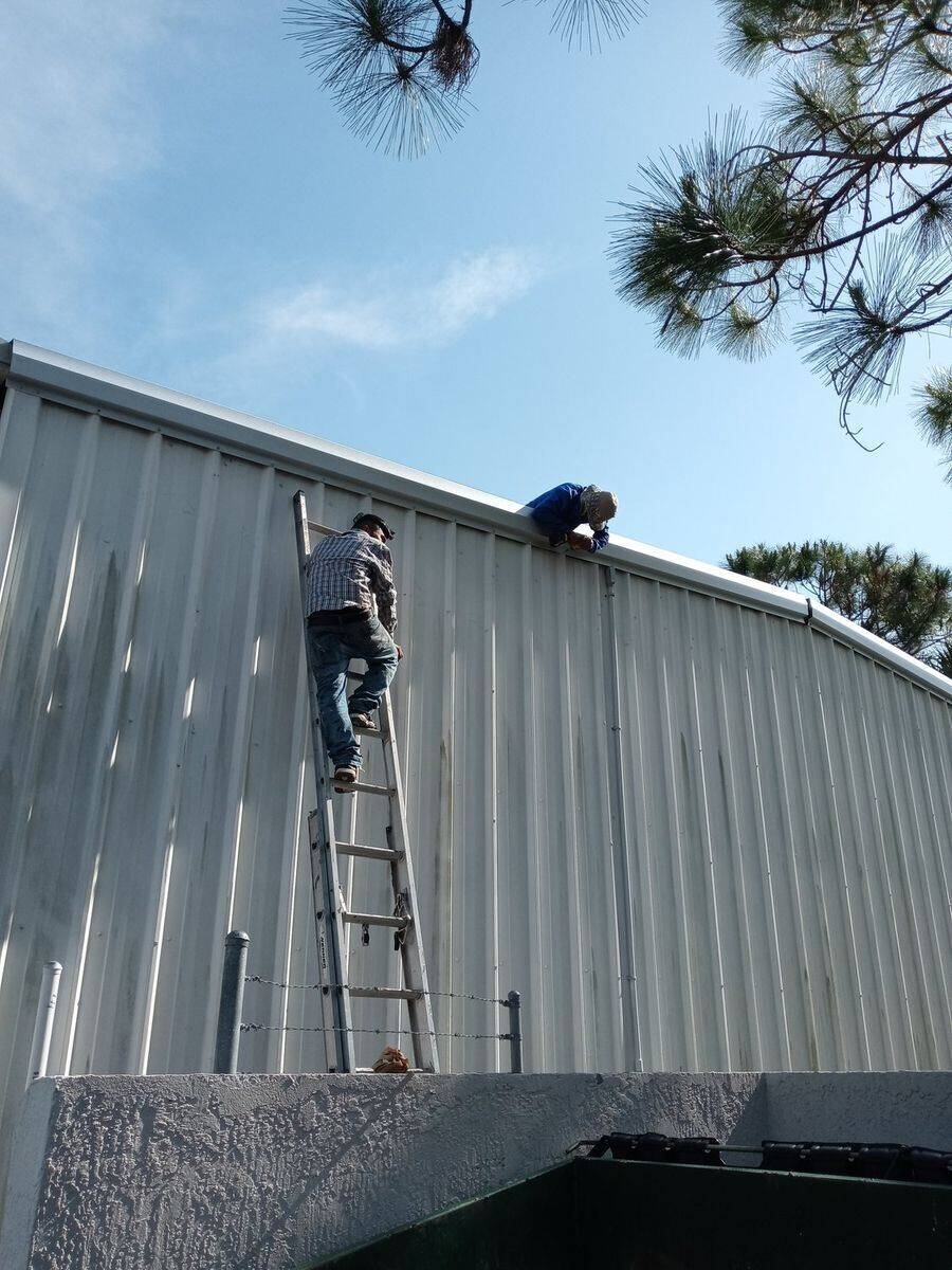 Bell Engineering and Construction crew installing a metal roof in Palm Beach County, Florida